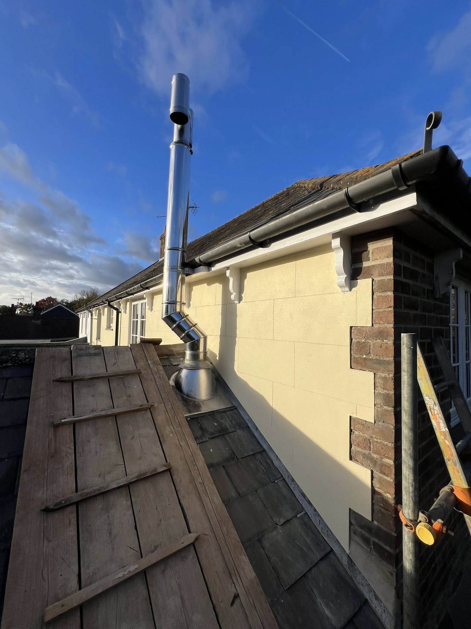 Chimney flue installation on slate roof