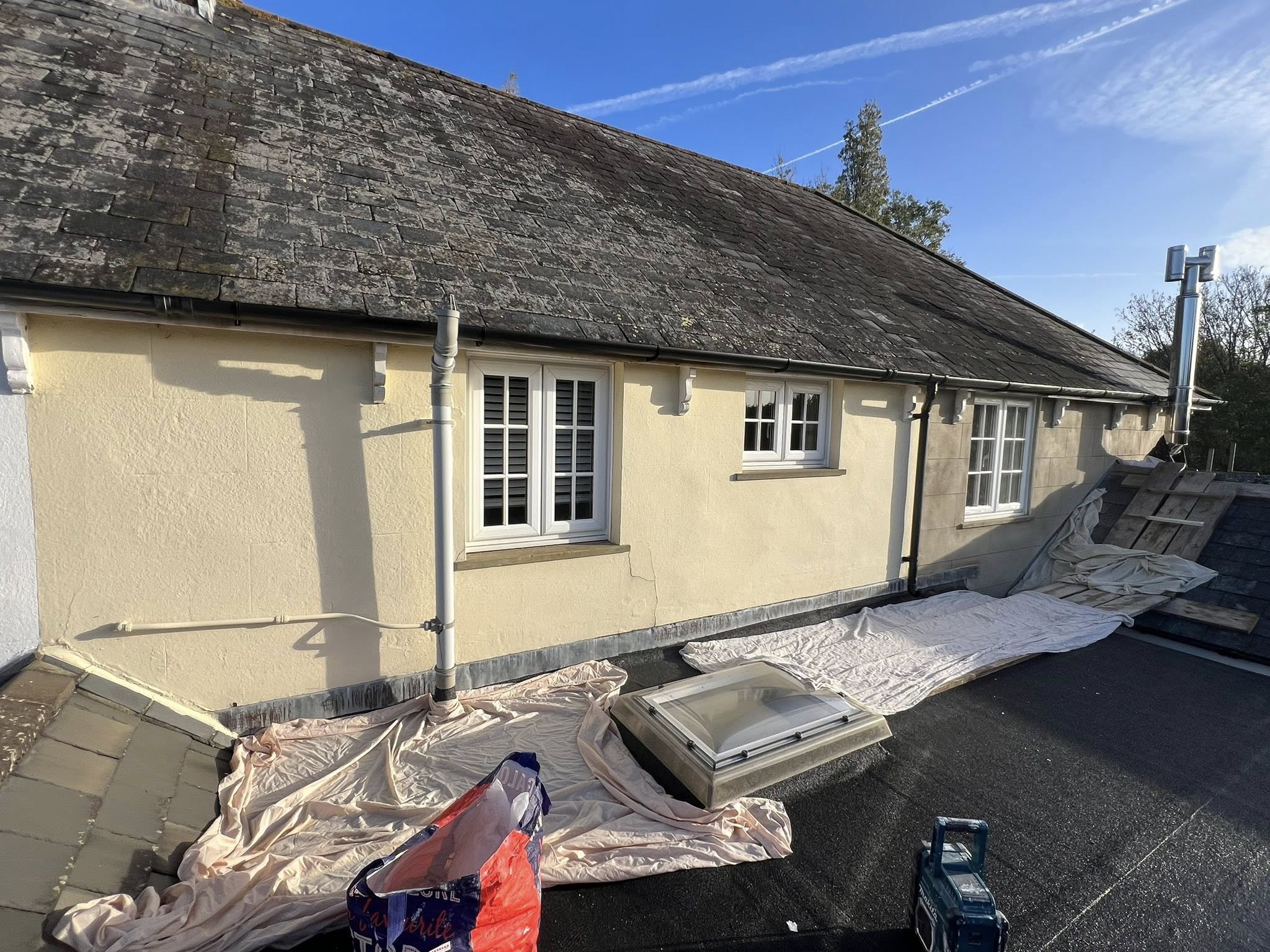 Painter masking and preparing building exterior