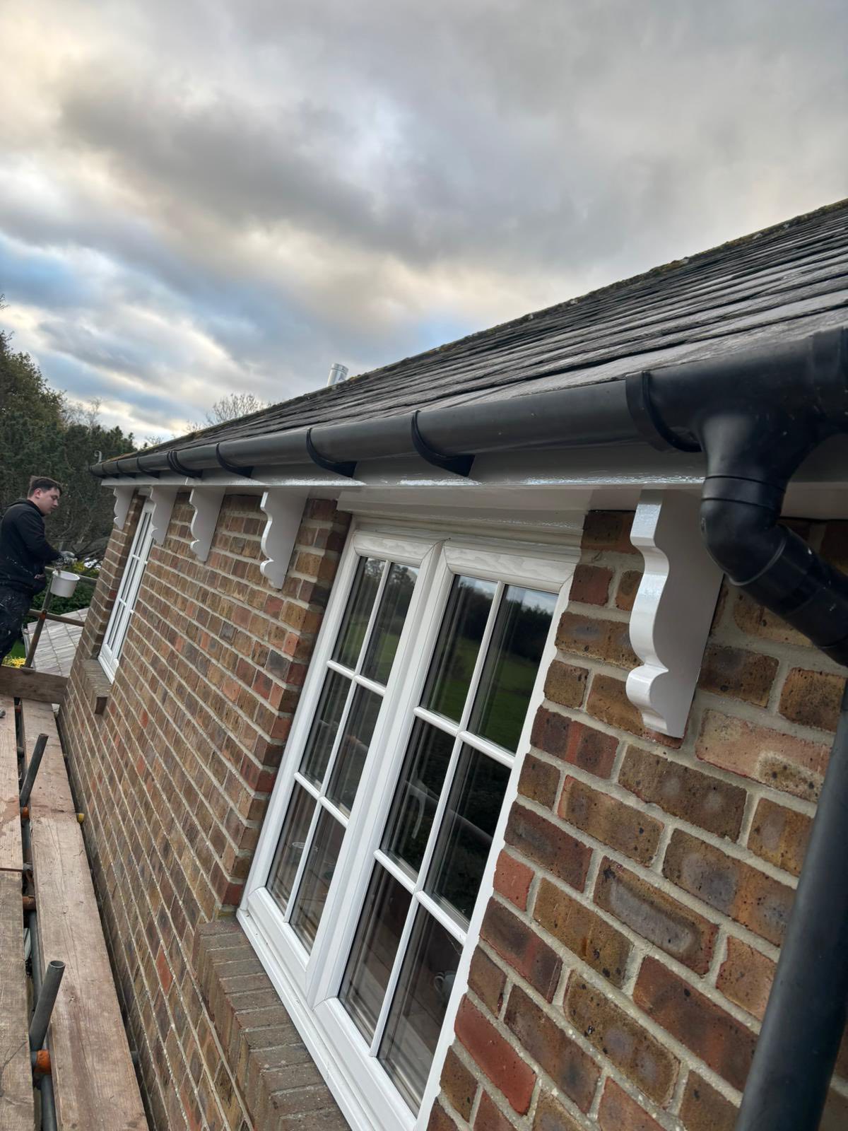 New black guttering and downpipes on brick house