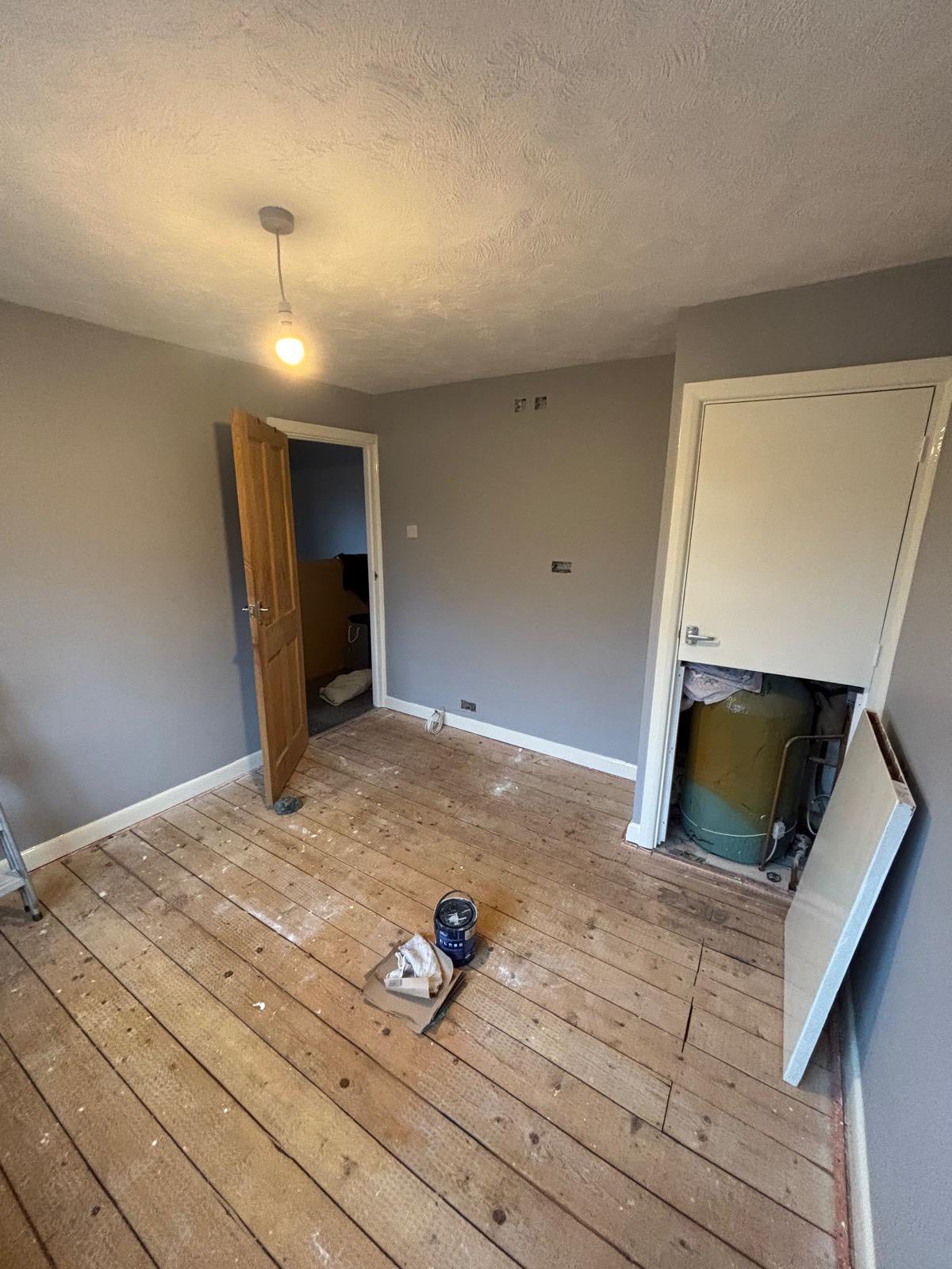 Room during decoration with exposed wooden floor