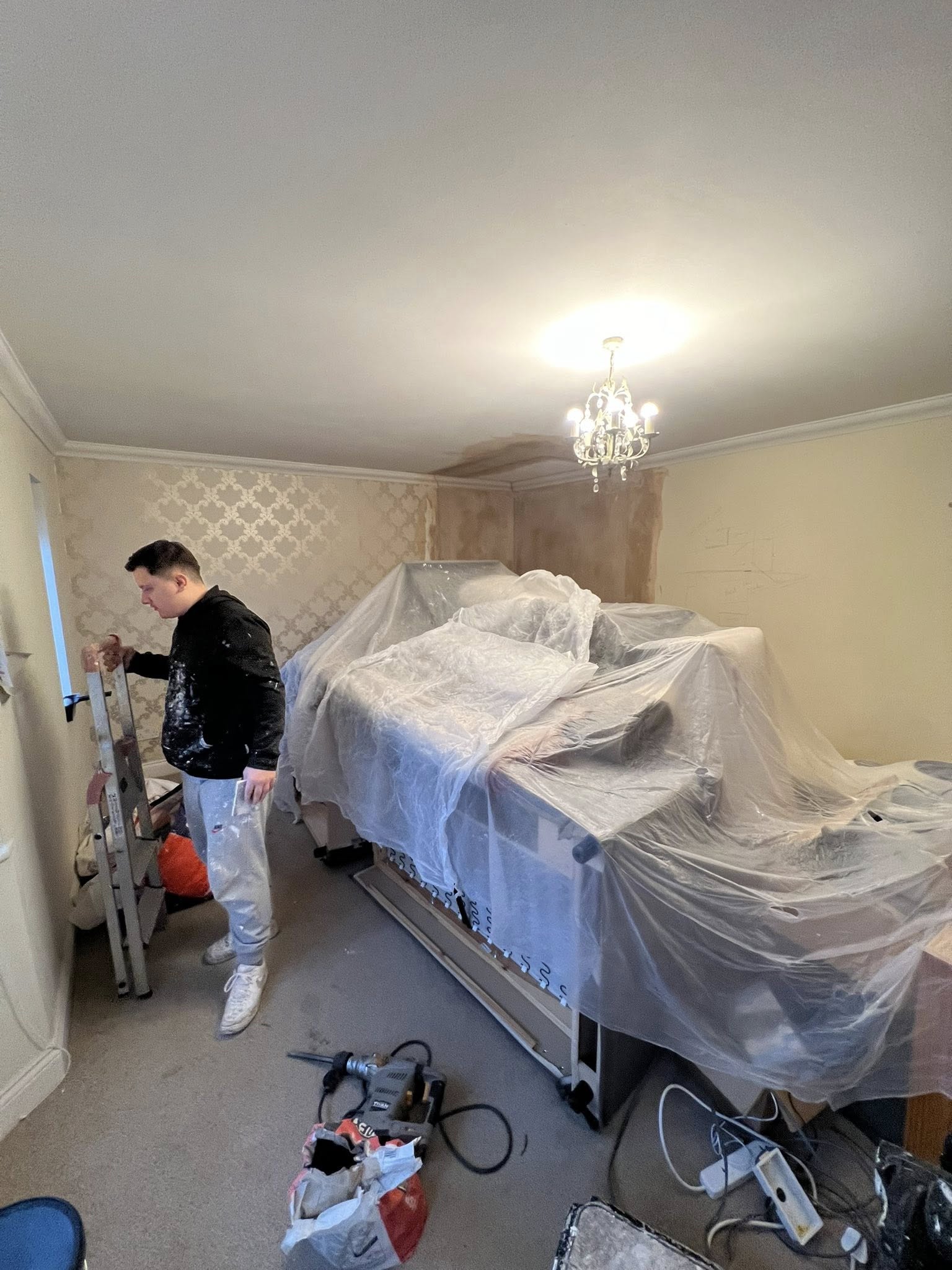 Painter preparing bedroom furniture